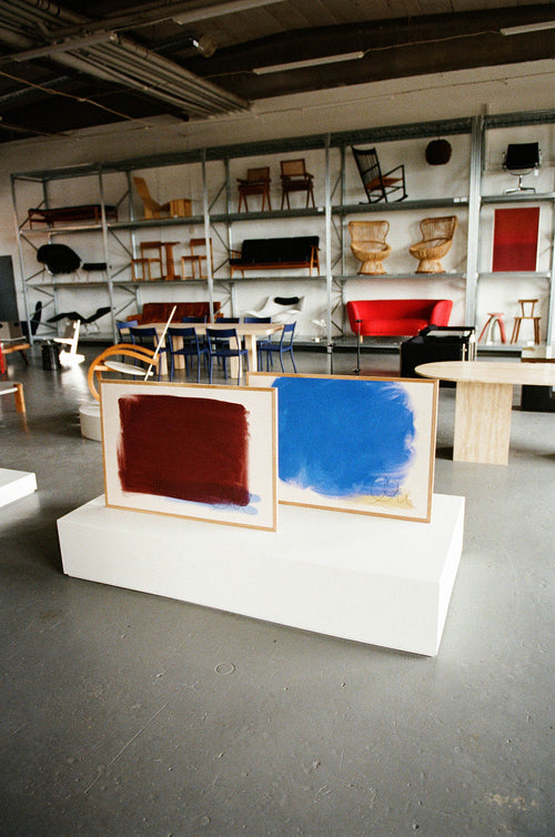 Art gallery with abstract paintings and furniture on shelves