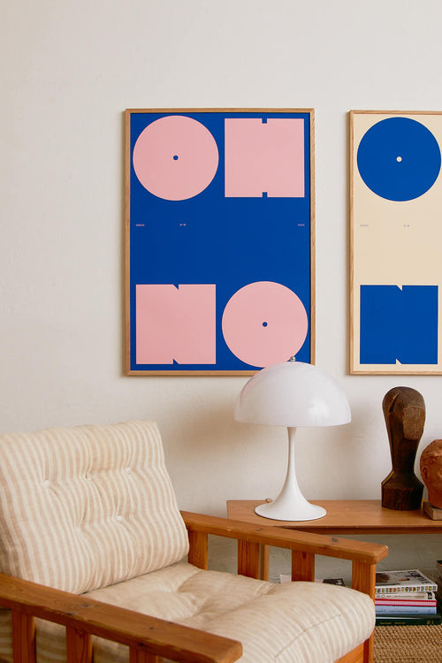 Modern living room with abstract art, chair, and lamp.