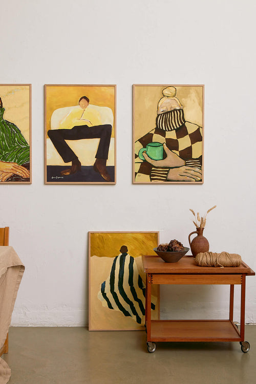 Artistic wall decorations in a room with a wooden table and decorative items.