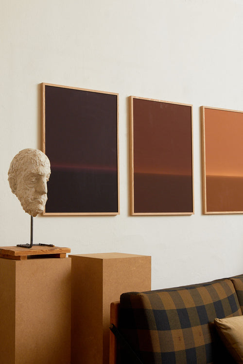 Art print with an abstract spray painting of a dark sky in deep purple tones. Styled in a minimalist interior.