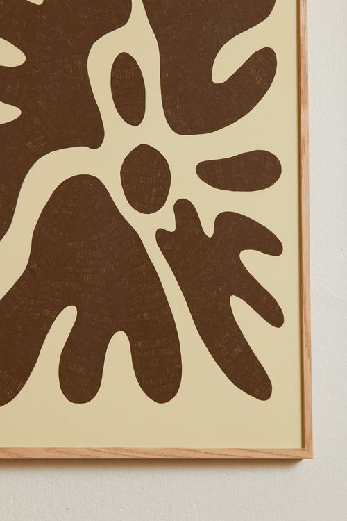 Art print featuring a minimalistic motif in warm brown and soft yellow-beige, with shapes that explore the space between abstraction and recognition through soft, fluid forms. Styled in a minimalist interior.