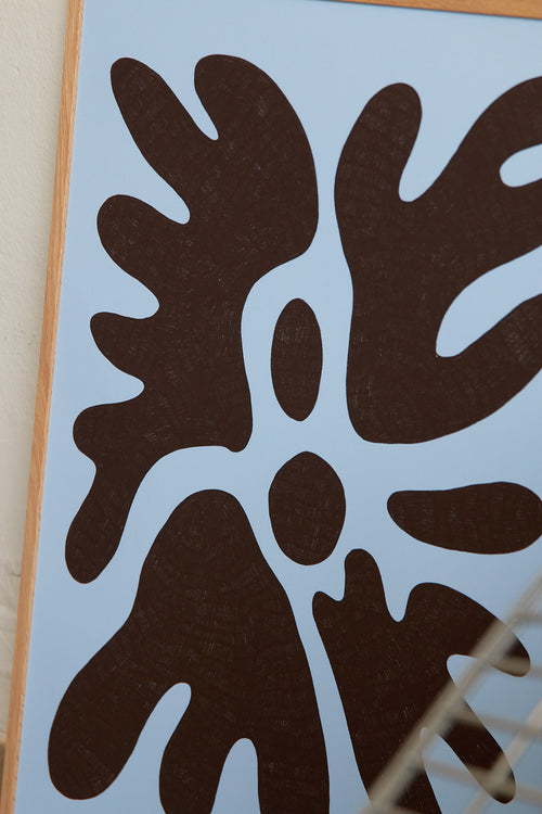 Art print featuring a minimalistic motif in chocolate brown and pastel blue, with shapes that explore the space between abstraction and recognition through soft, fluid forms. Styled in a minimalist interior.