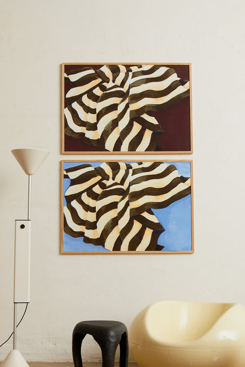 Art print featuring a painting of a plaid against a sky-blue background, flowing with wide stripes in dark chocolate brown and creamy white. Styled in a minimalist interior.