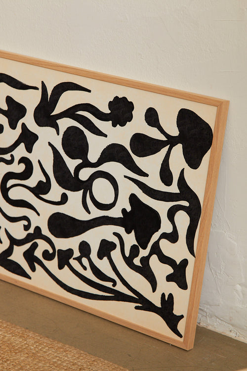 Art print with a minimalist illustration of black, organic, hand-drawn lines against an off-white background. Styled in a minimalist interior.