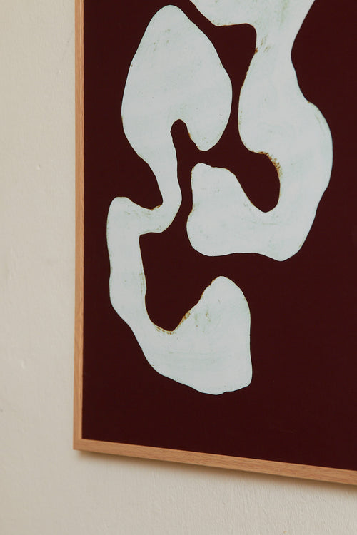 Art print featuring two analogue-themed components wrapping around one another in ice blue against a burgundy background. Styled in a minimalist interior.