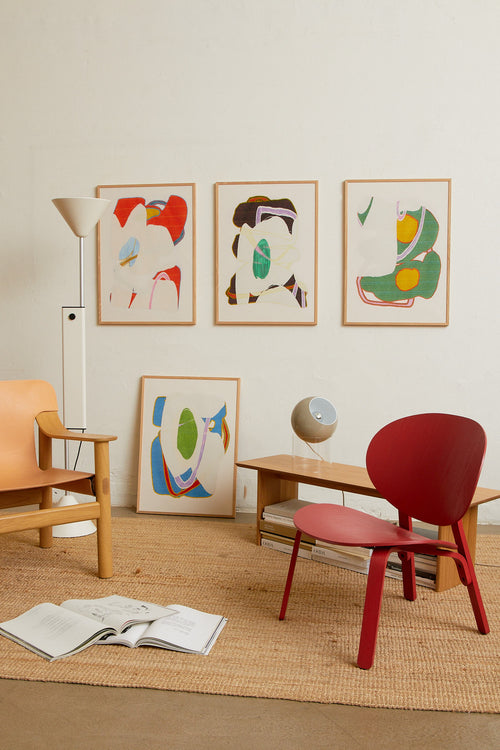 Art print with an abstract artwork featuring soft, overlapping shapes and a grainy texture. Green tones meet light fields and are framed by a distinct yellow core. Styled in a minimalist interior.