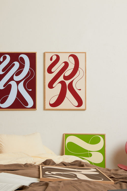 Art print featuring exploratory organic forms emerging in beige and red. Styled in a minimalist interior.