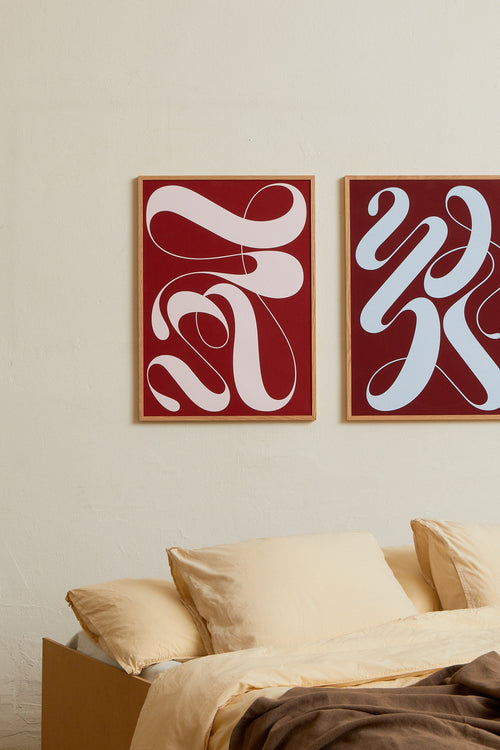 Art print featuring exploratory organic forms emerging in red and pink. Styled in a minimalist interior.