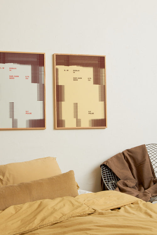 Art print with a graphic illustration of rectangular fields and linear patterns, combined with small text elements, in brown and beige RAL colors. Styled in a minimalist interior.