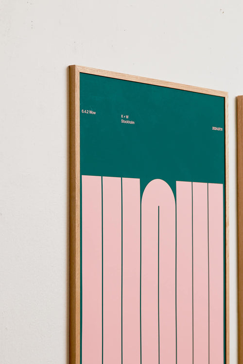 Framed artwork with a green top section and pink bottom section on a white wall.