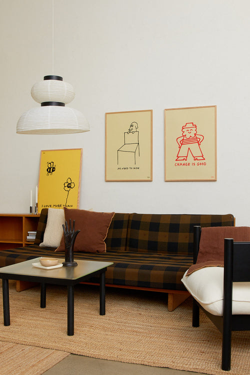 Living room with a couch, coffee table, and wall art