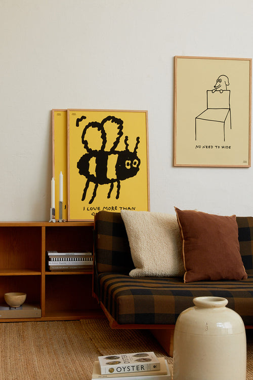 Living room with a sofa, bookshelf, and wall art