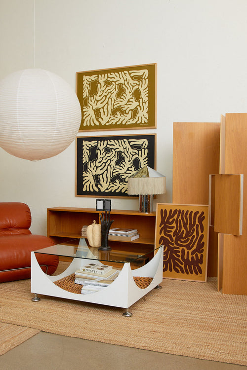 Modern living room with wooden furniture, abstract wall art, and a red sofa.