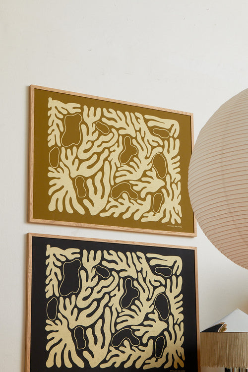 Two abstract art pieces with geometric patterns on a wall.