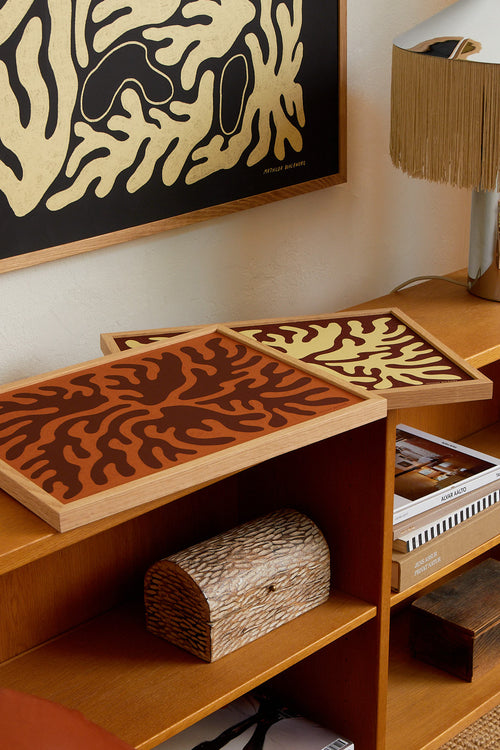 Wooden shelves with decorative items and a framed abstract artwork on the wall.