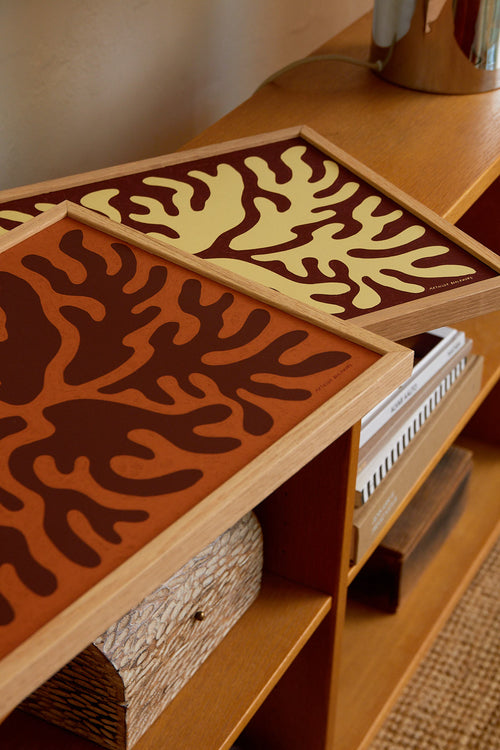 Wooden trays with coral patterns on a wooden shelf