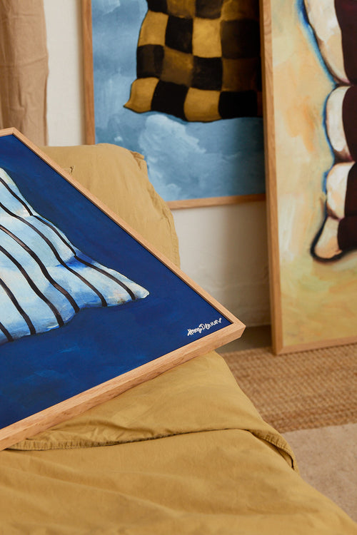 Close-up of a painting with a blue background and a checkered flag in the background.