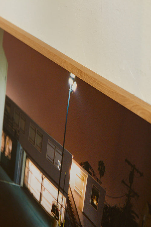 Model of a building with a streetlight on a reflective surface