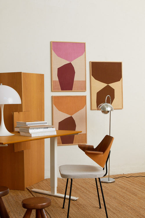Modern interior with wooden furniture, abstract art, and a lamp.