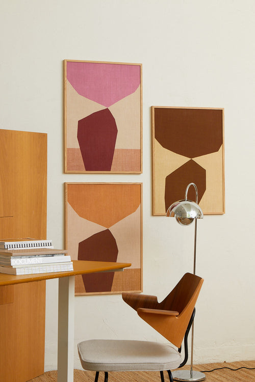 Modern interior with wooden desk, chair, and abstract wall art