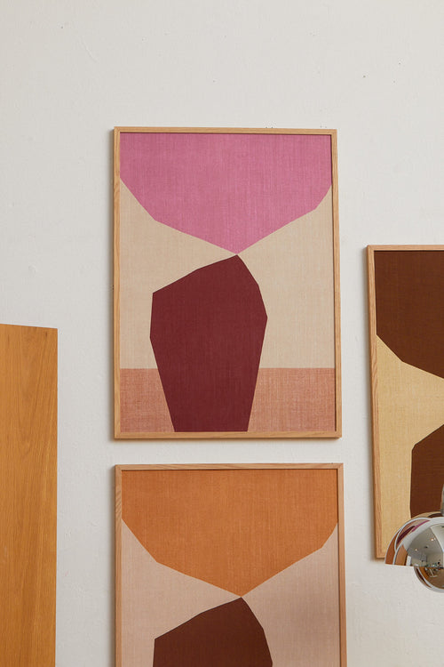 Abstract art pieces with geometric shapes on a wall.