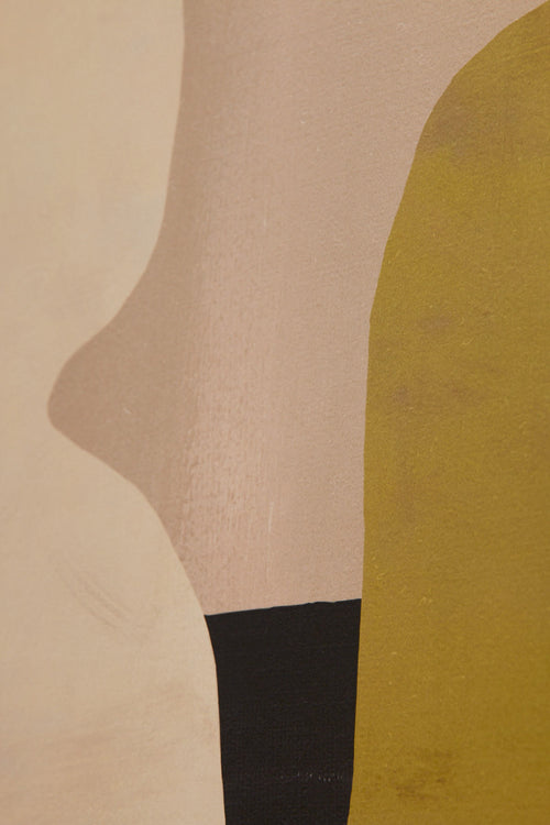 Close-up of a foot wearing a black sock with a beige background