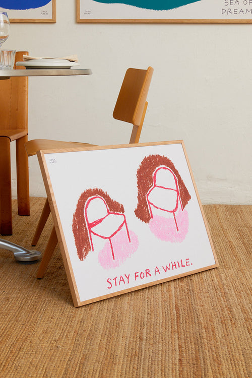 Framed artwork with a drawing of two faces and 