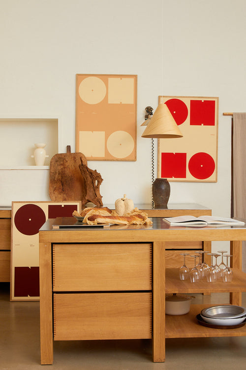 Wooden desk with decorative items and abstract art in a room setting