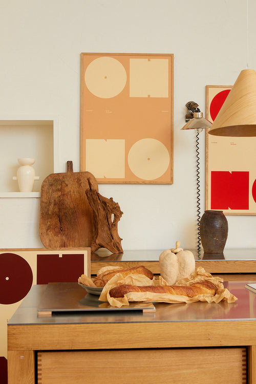 Modern interior with wooden furniture, abstract art, and a lamp.