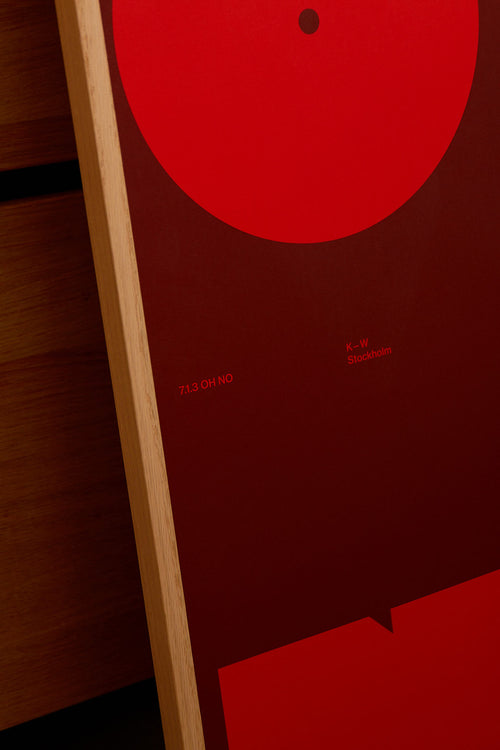 Close-up of a red circular object with text on a wooden surface
