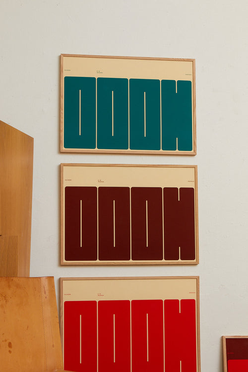 Three framed art pieces with geometric designs on a wall.