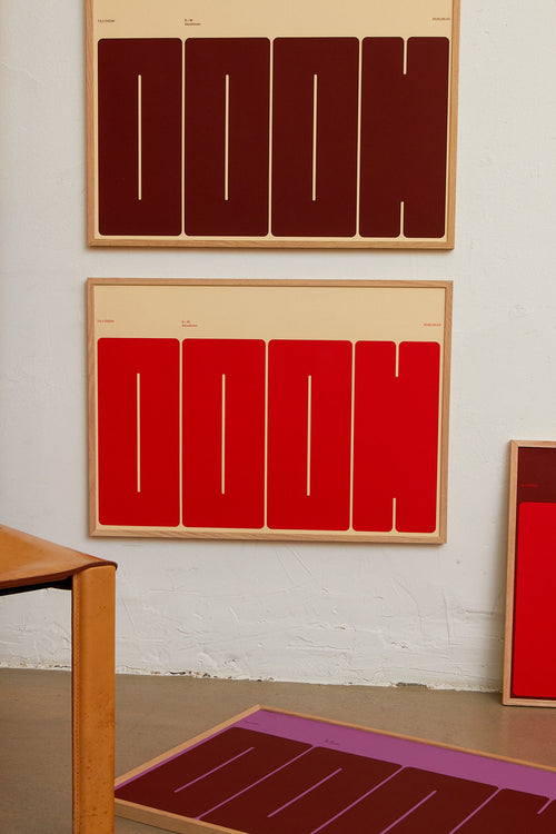 Three abstract artworks with geometric patterns on a wall.