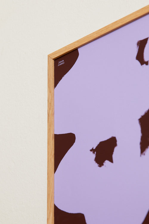 Framed artwork with brown abstract shapes on a purple background