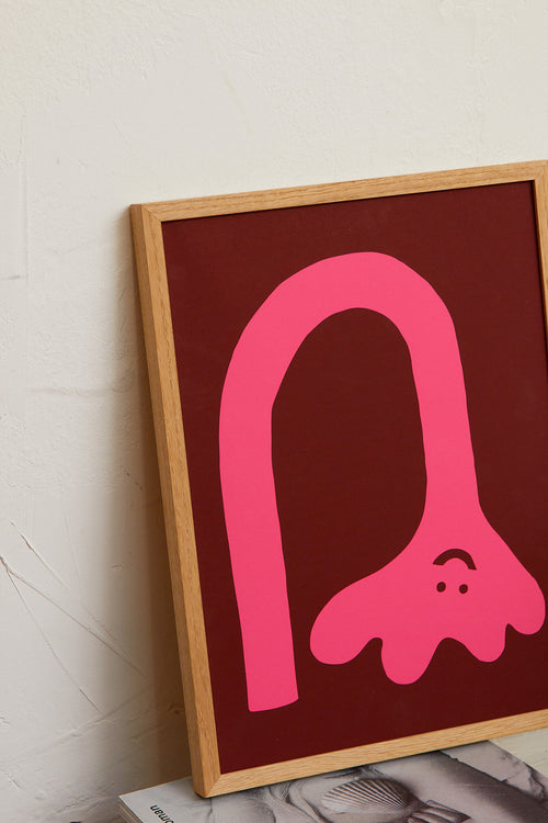 Framed artwork with a pink abstract design on a red background