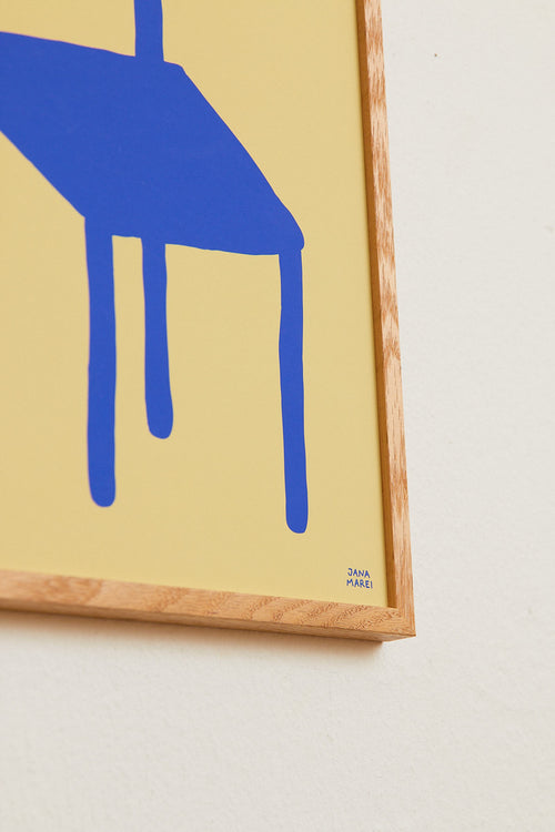 Framed artwork with a blue abstract shape on a beige background
