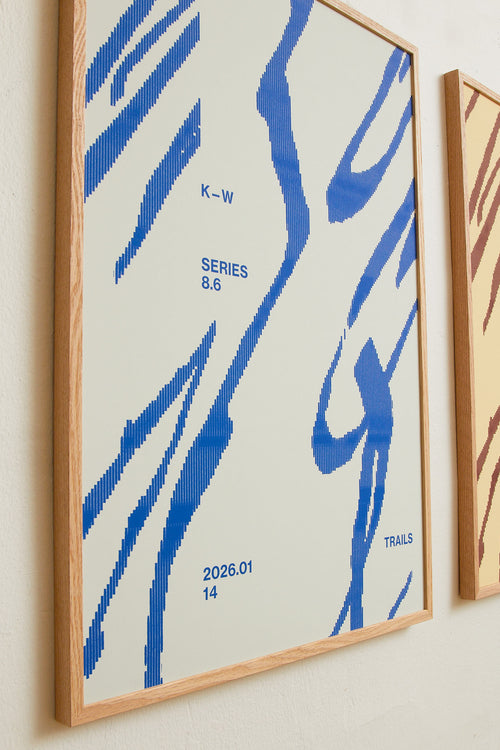 Art print with a graphic illustration of sweeping, organic forms built from dense lines, complemented by small text elements, in blue RAL colors. Styled in a minimalist interior.