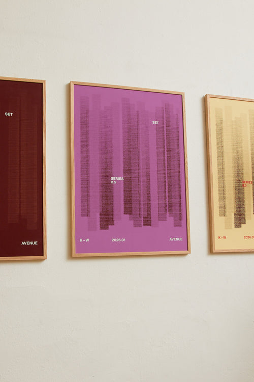 Art print with a graphic illustration of vertical fields built from dense lines, complemented by small text elements, in red and purple RAL colors. Styled in a minimalist interior.