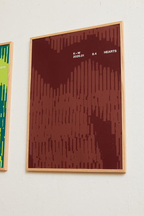 Art print with a graphic illustration of organic, vertical line patterns forming abstract shapes, complemented by small text elements, in brown and red RAL colors. Styled in a minimalist interior.