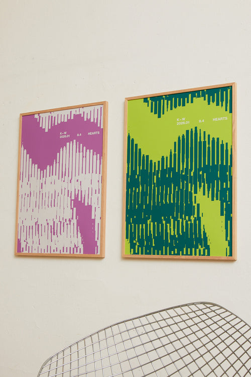 Art print with a graphic illustration of organic, vertical line patterns forming abstract shapes, complemented by small text elements, in green RAL colors. Styled in a minimalist interior.