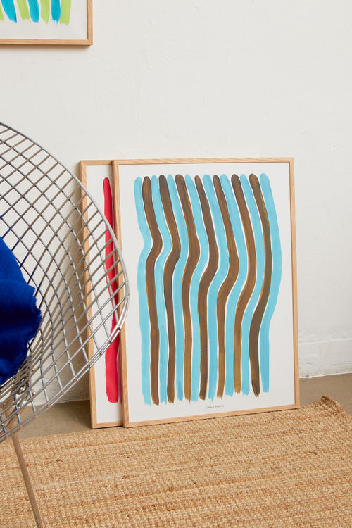 Framed turquoise striped print styled in a modern interior.