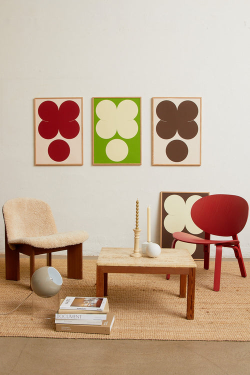 Art print featuring playful, bold typography of the letters X and O, hugs and kisses, in brown against a sand beige background. Styled in a minimalist interior.