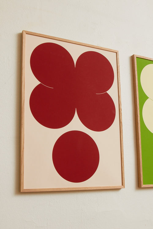 Art print featuring playful, bold typography of the letters X and O, hugs and kisses, in red against a beige background. Styled in a minimalist interior.