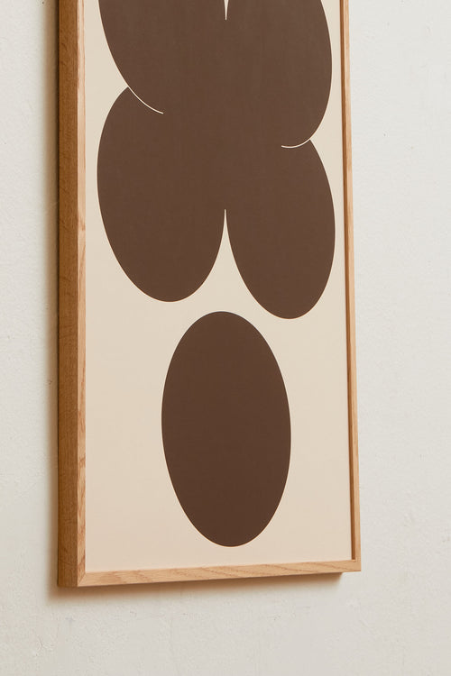 Art print featuring playful, bold typography of the letters X and O, hugs and kisses, in brown against a sand beige background. Styled in a minimalist interior.