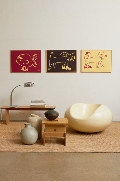 Interior scene with the red fish print displayed alongside other colorful artworks on a wall