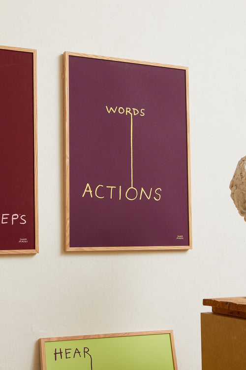 Interior scene with burgundy and blue minimalist prints displayed on a wall