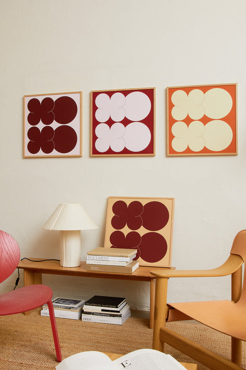 Square-format Art print featuring playful, bold typography of the letters X and O, hugs and kisses, in pink against a red background. Styled in a minimalist interior.