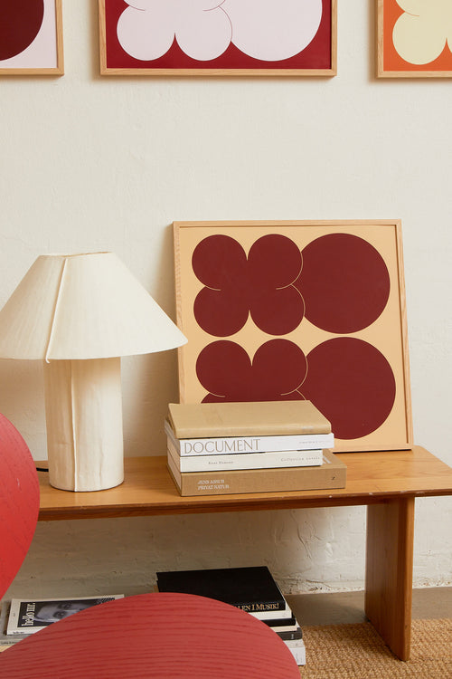 Square-format Art print featuring playful, bold typography of the letters X and O, hugs and kisses, in two shades of brown. Styled in a minimalist interior.