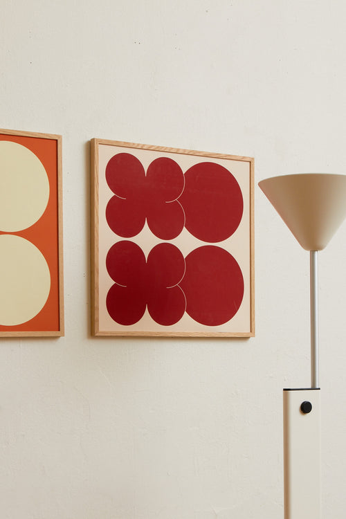 Square-format Art print featuring playful, bold typography of the letters X and O, hugs and kisses, in red against a beige background. Styled in a minimalist interior.