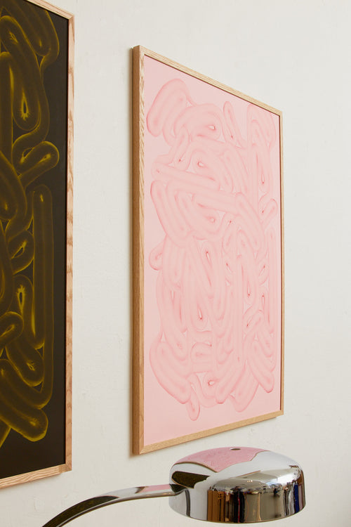 Art print with dense, rounded shapes in two shades of pink with a smooth, glossy feel. Styled in a minimalist interior.