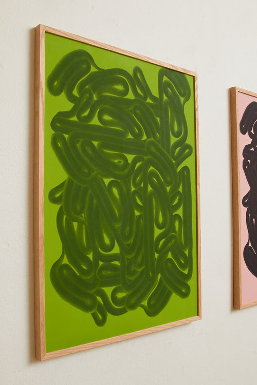 Art print featuring dense, rounded forms in two shades of green with a smooth, glossy feeling. Styled in a minimalist interior.
